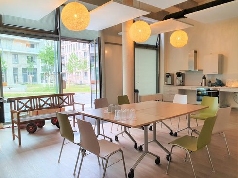 Treffpunkt Mitte Altona Innenansicht: Heller Raum mit einem Tisch und vielen Stühlen